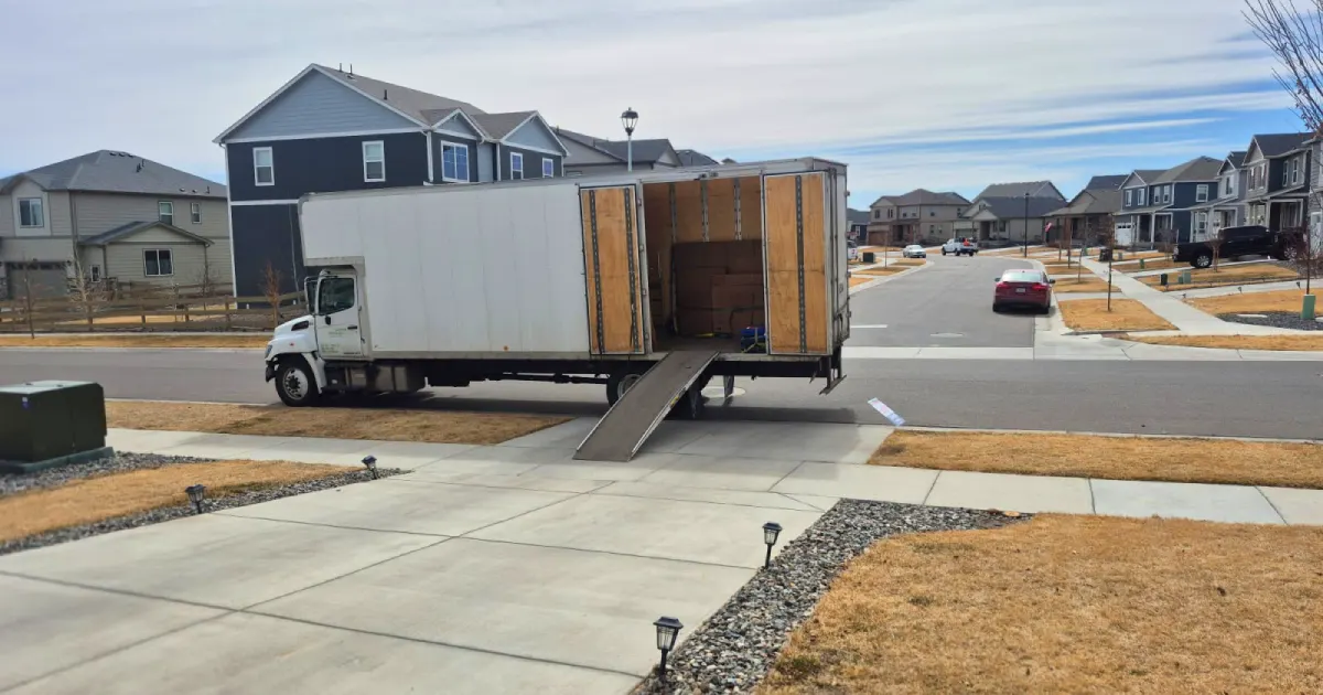 a moving truck parked outside a home in a denver suburb, ready to offer professional moving services
